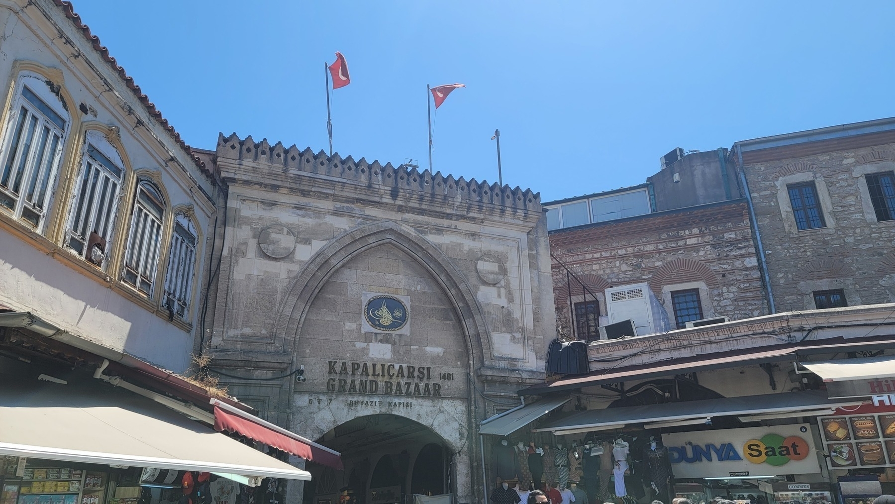 arch with Grand Bazaar on it and two Turkish flags flying above it