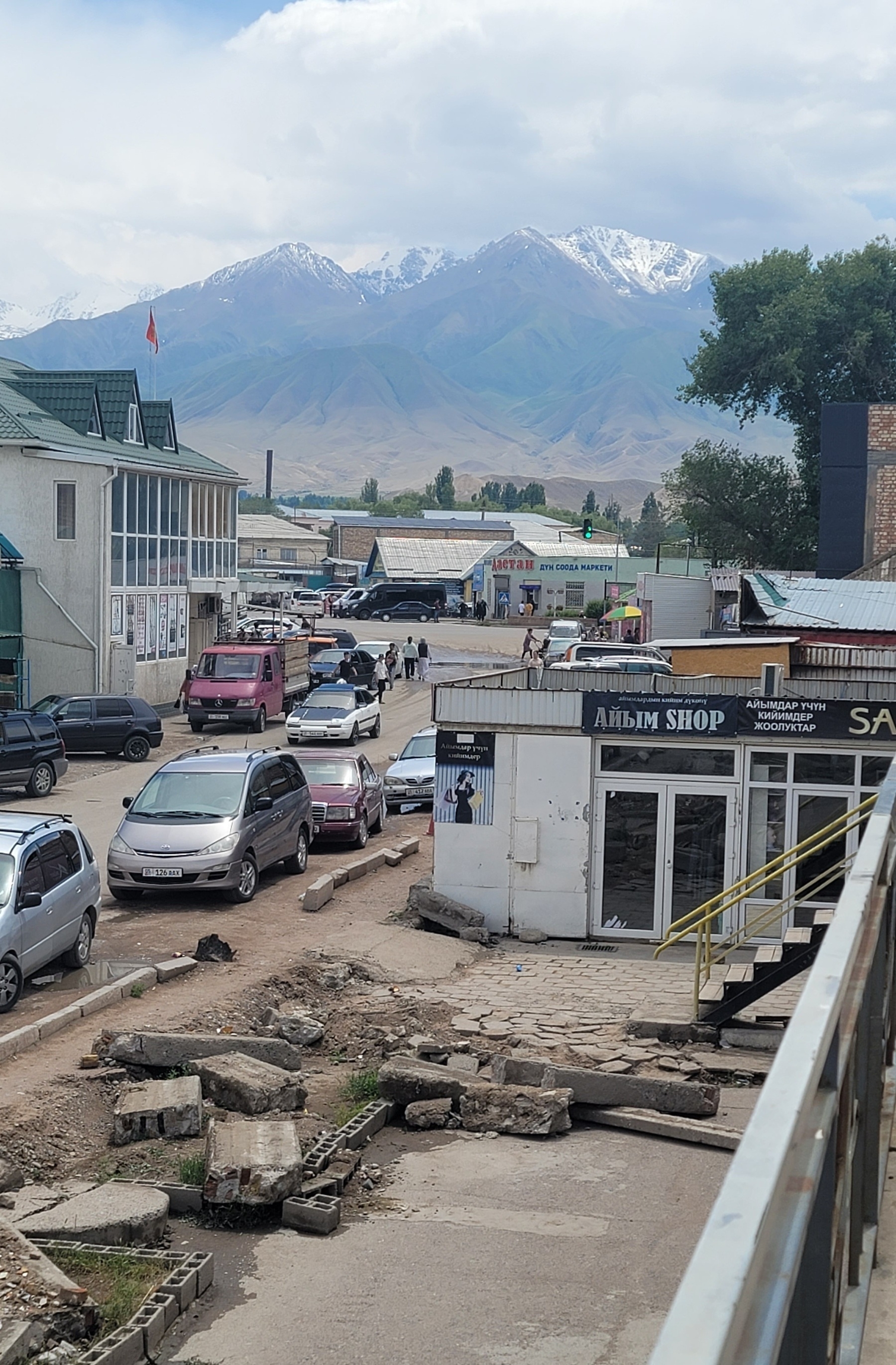 view of a road with buildings on both sides and mountains in the background