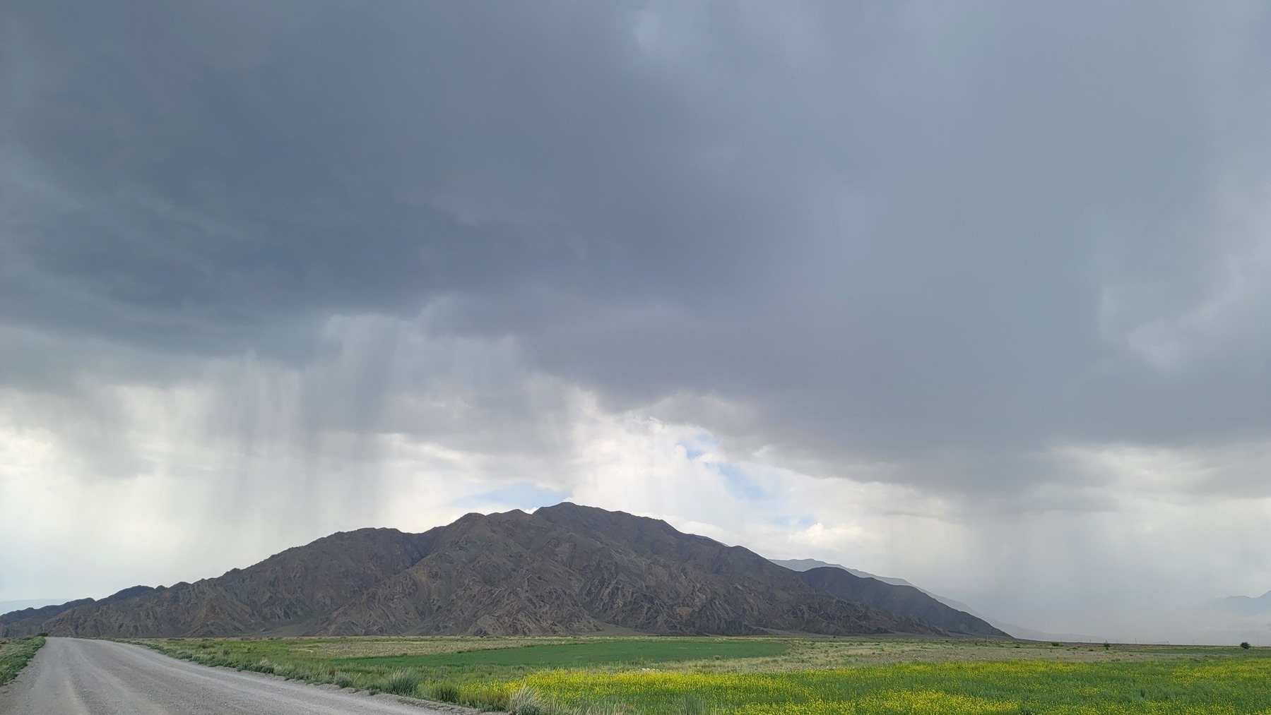 rain falling on and around a hill/small mountain