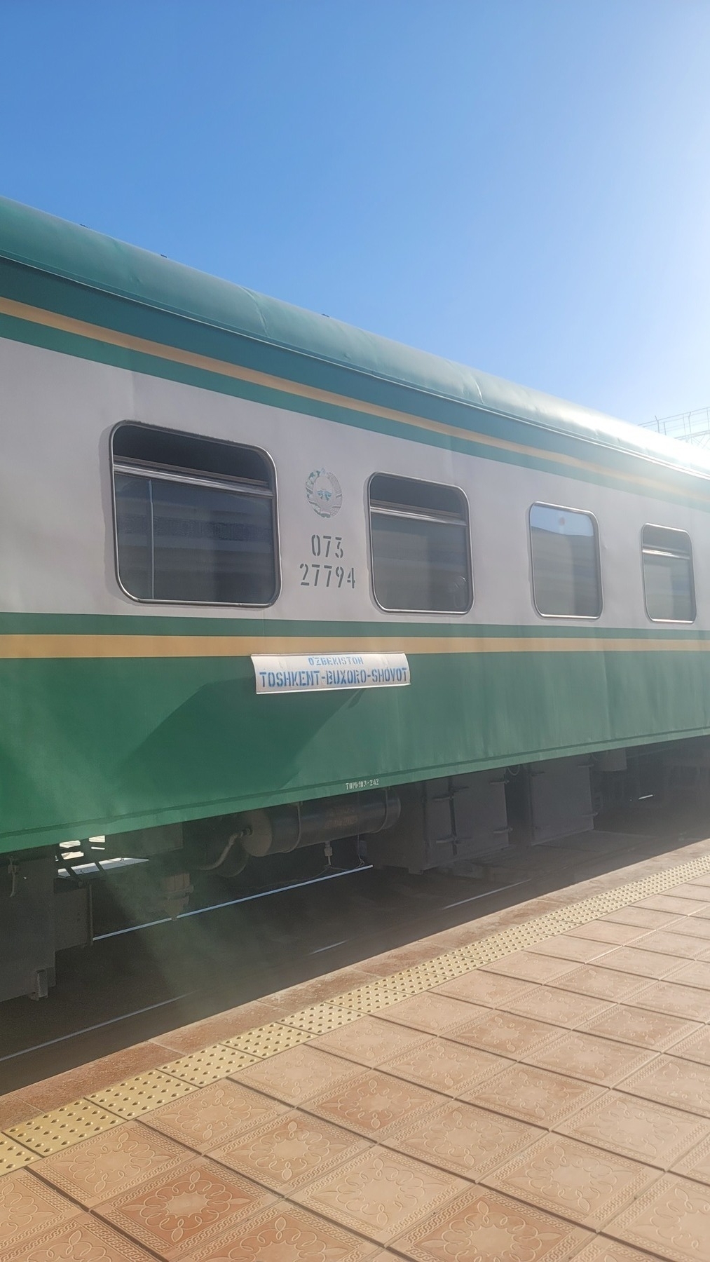 the outside of a train with a sign that reads "Tashkent-Bukhara-Shovot"