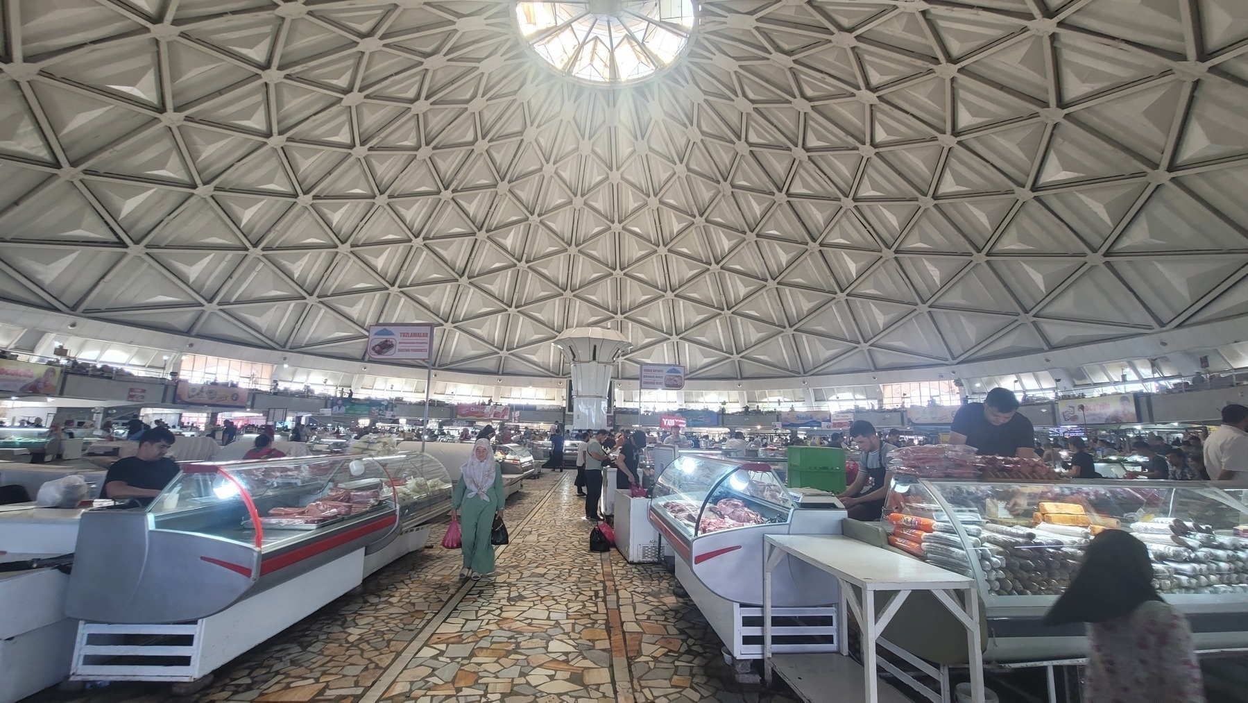 food vendors inside a large building with a dome