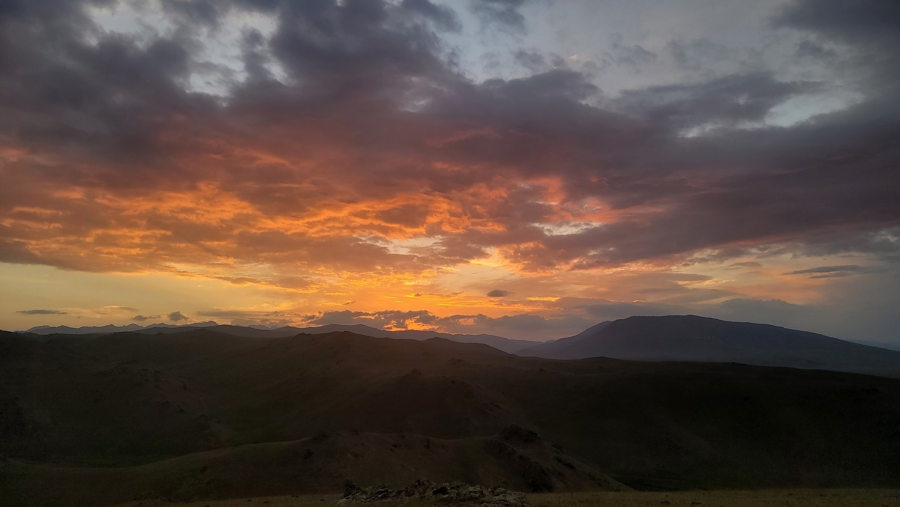 orange and gray sunrise above mountains