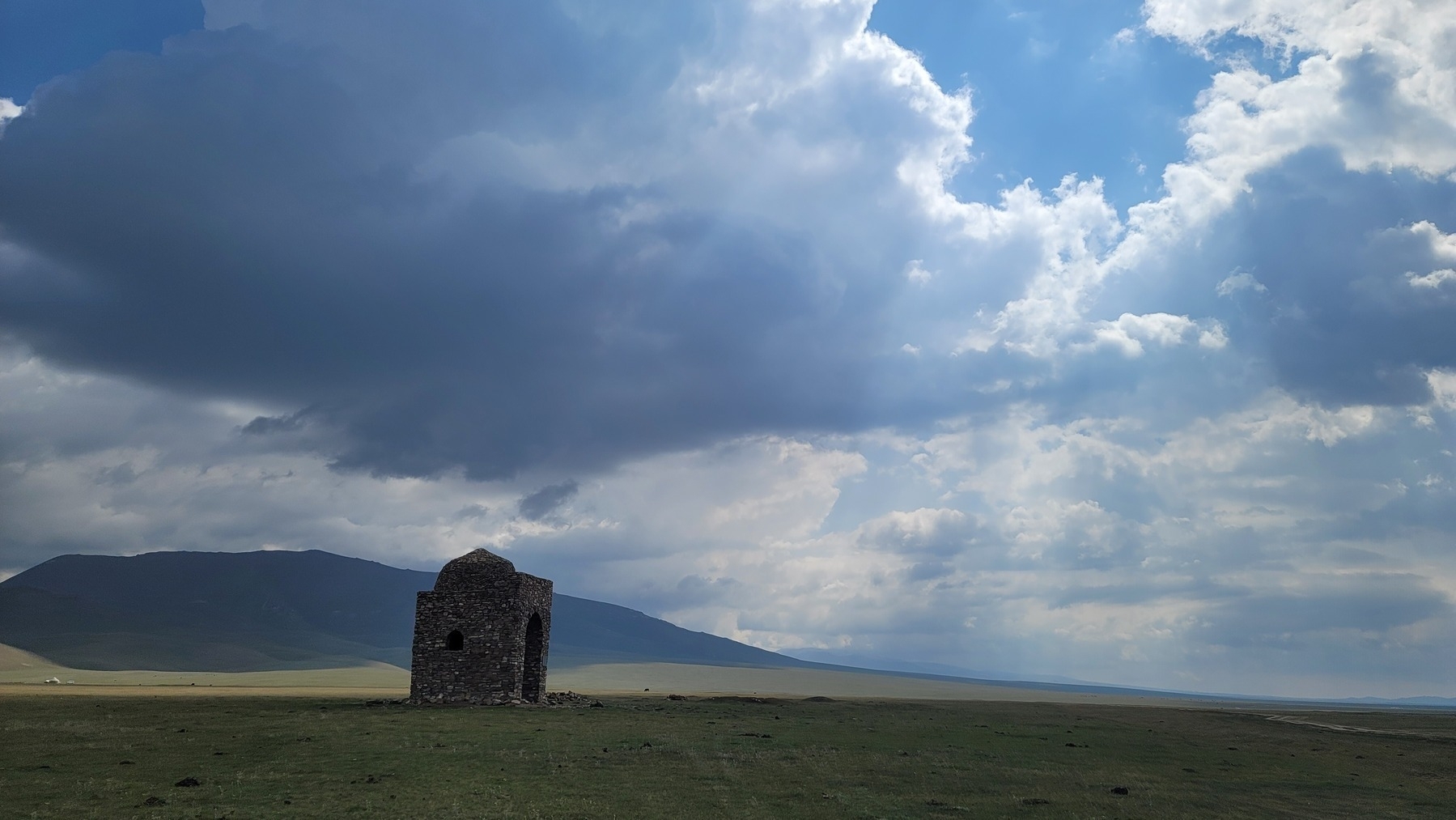 small tomb/mausoleum building in the distance 