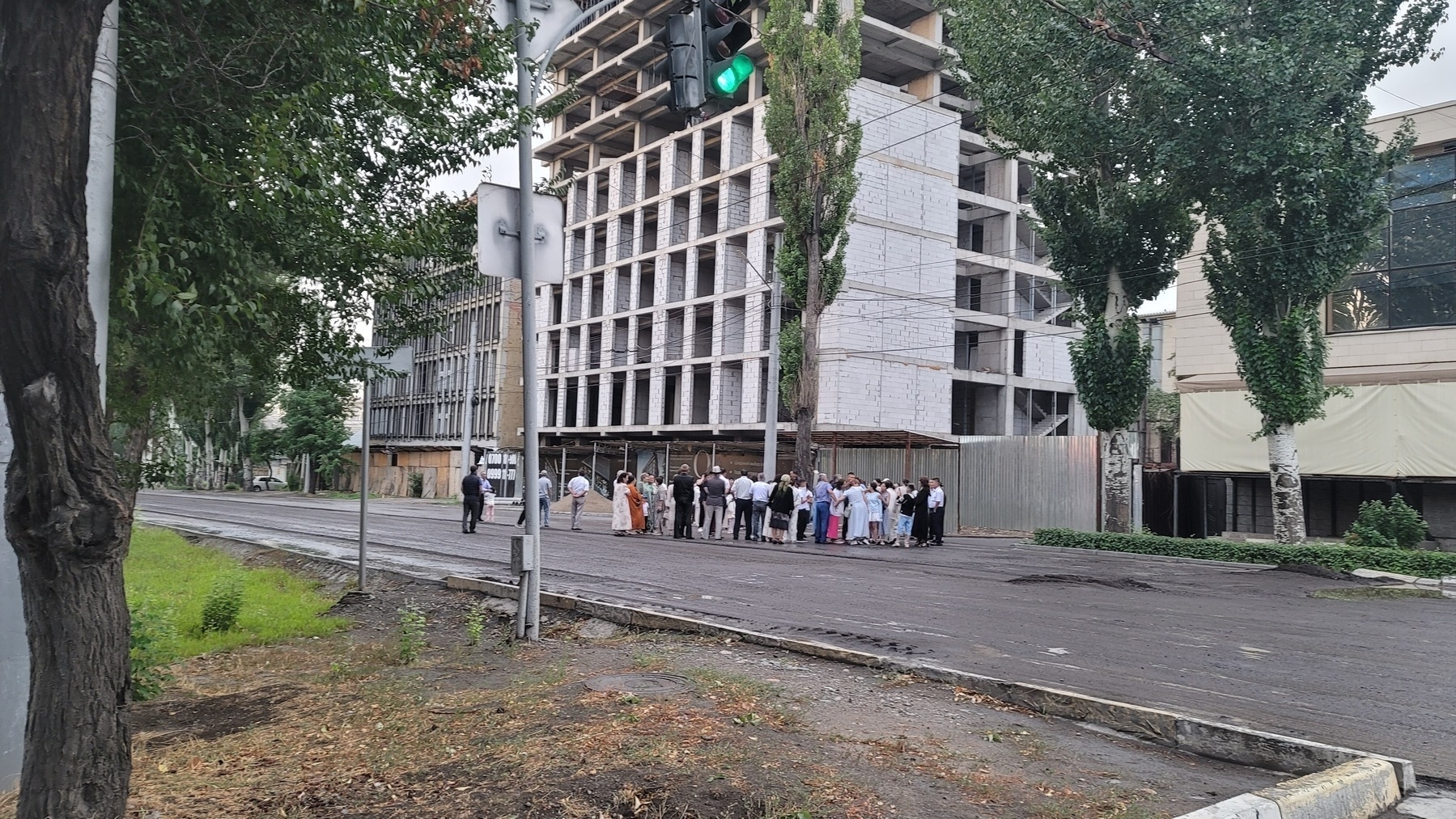 group of people in nice clothes standing on a road without cars