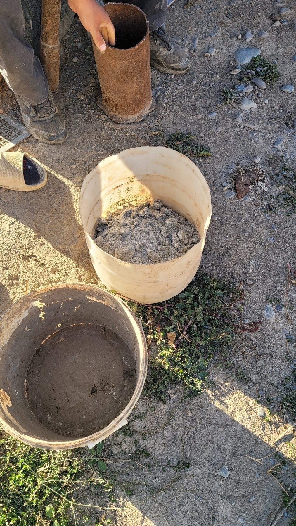 ground-up salt with small chunks in the bottom half of an old bottle plastic container