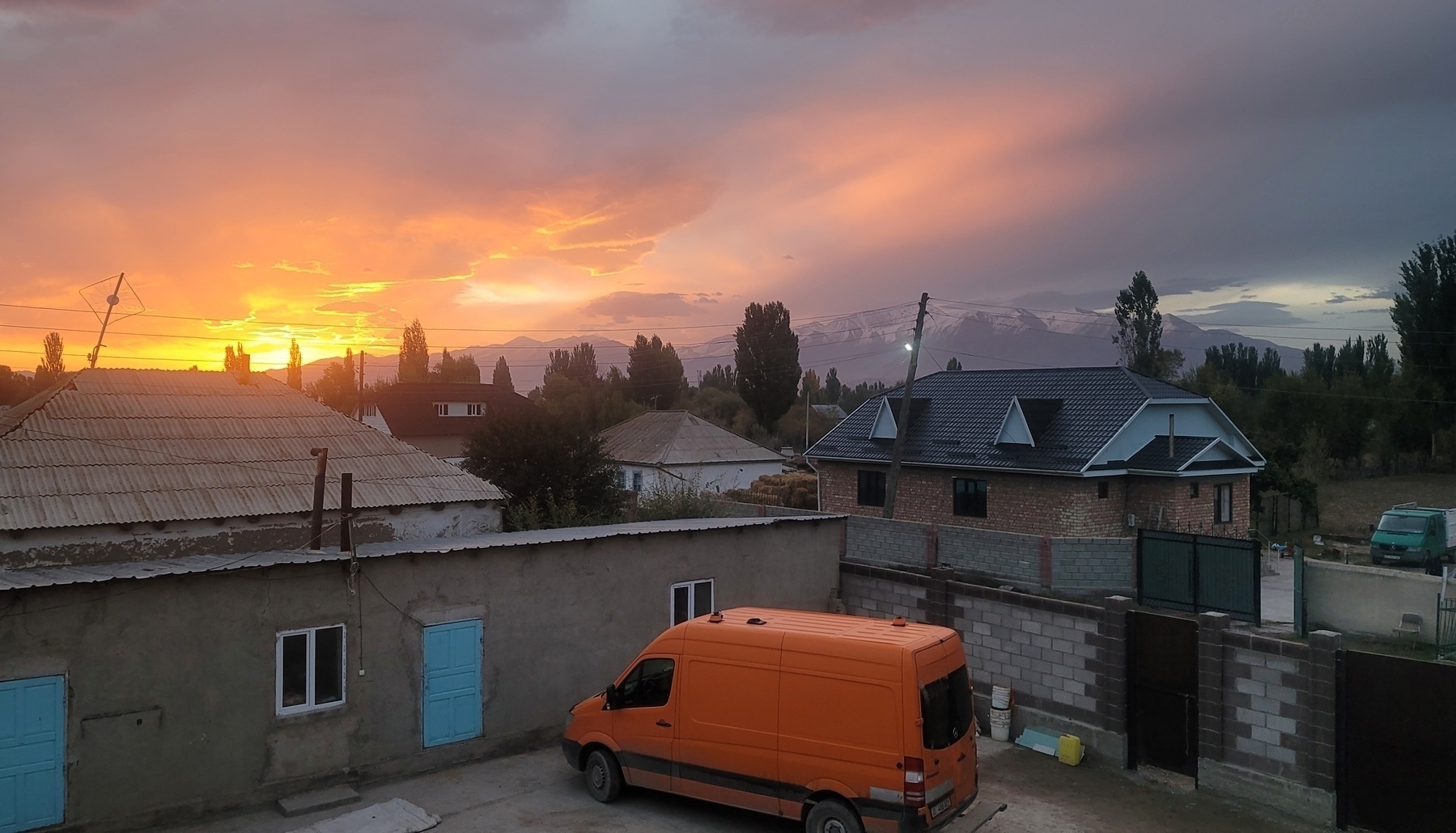 sunrise over a neighborhood from a second floor view