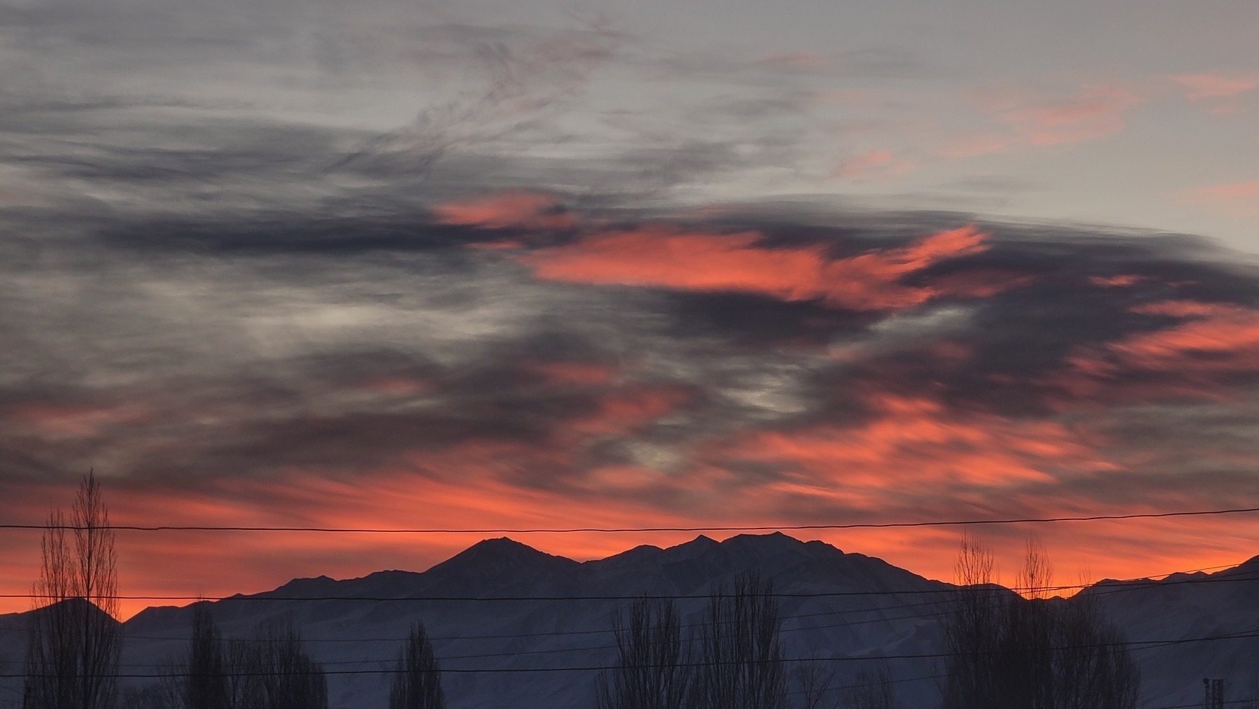 pink and gray sunrise over snowy mountains