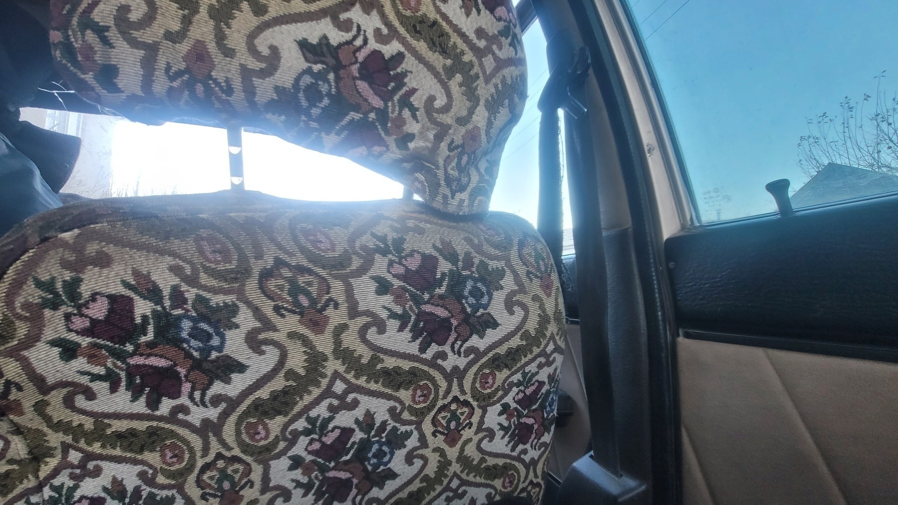 back of the passenger car seat with floral upholstery 