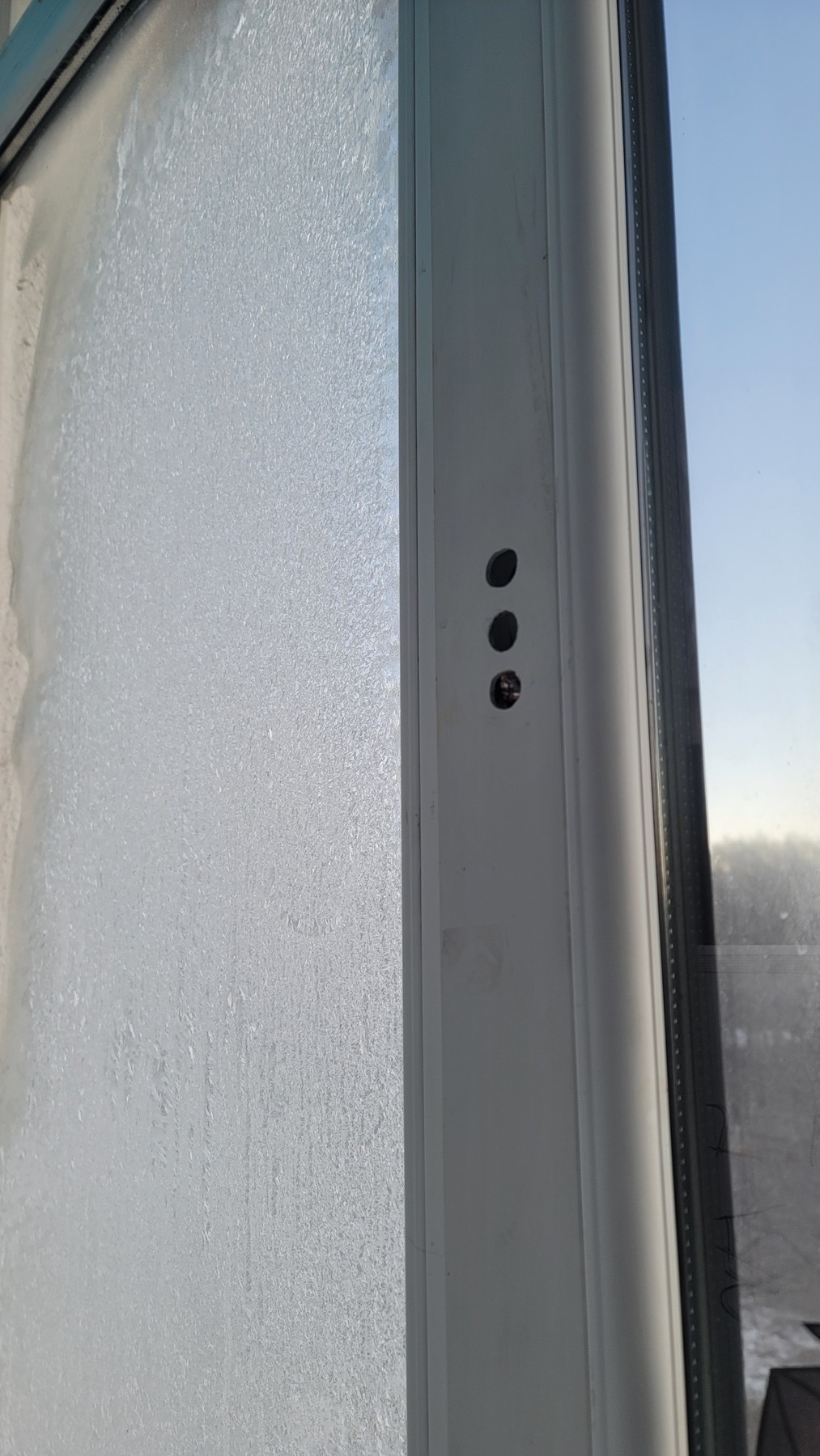 windowpane on left covered with (about to melt) ice; normal windowpane on right