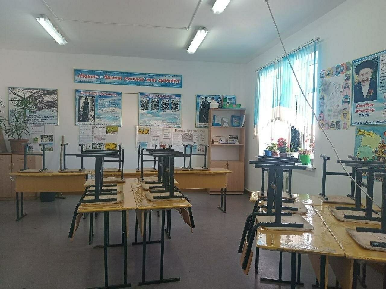 bright, clean classroom with chairs on top of the desks