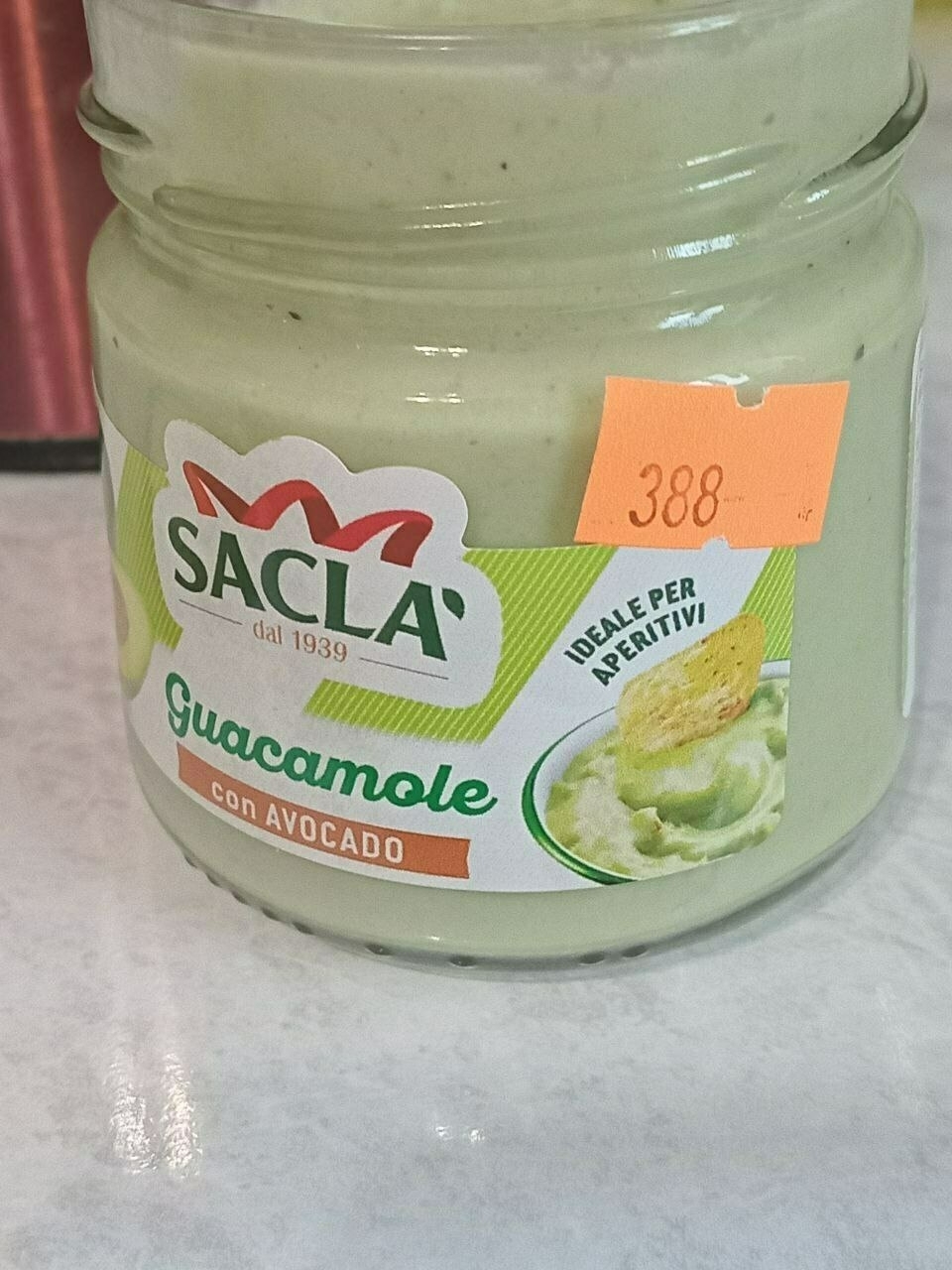 small jar of light green guacamole with an orange price sticker reading 388 