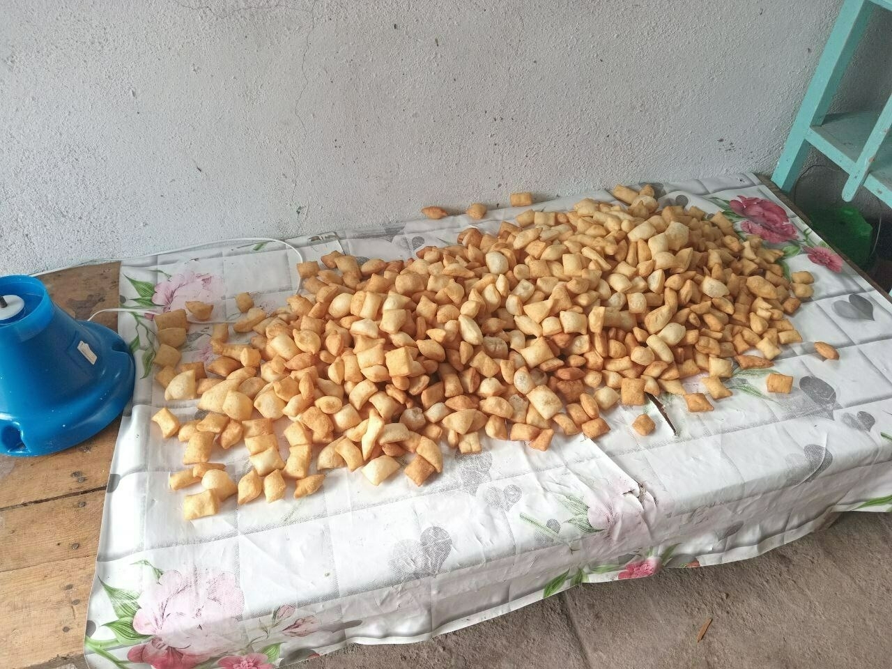 table with a large pile of small pieces of fried dough (boorsok)