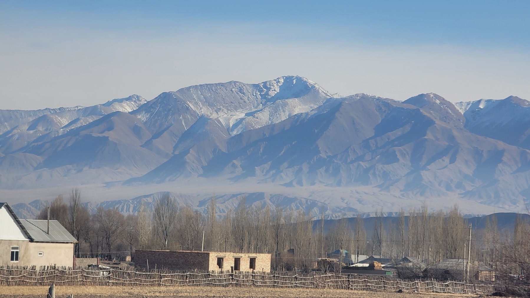 mountains in the background, two houses in the foreground