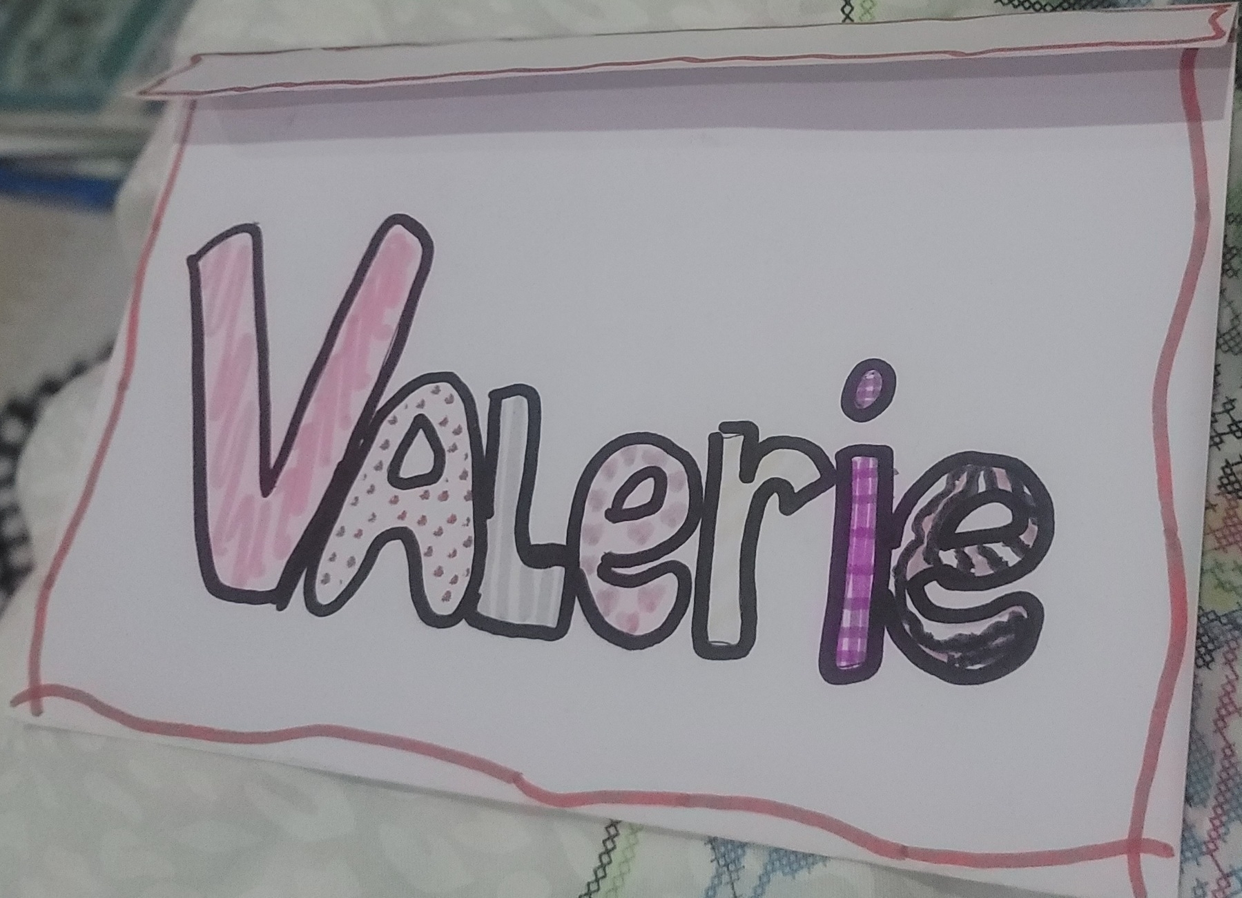 simple envelope made out of a white sheet of paper with my name drawn on in marker