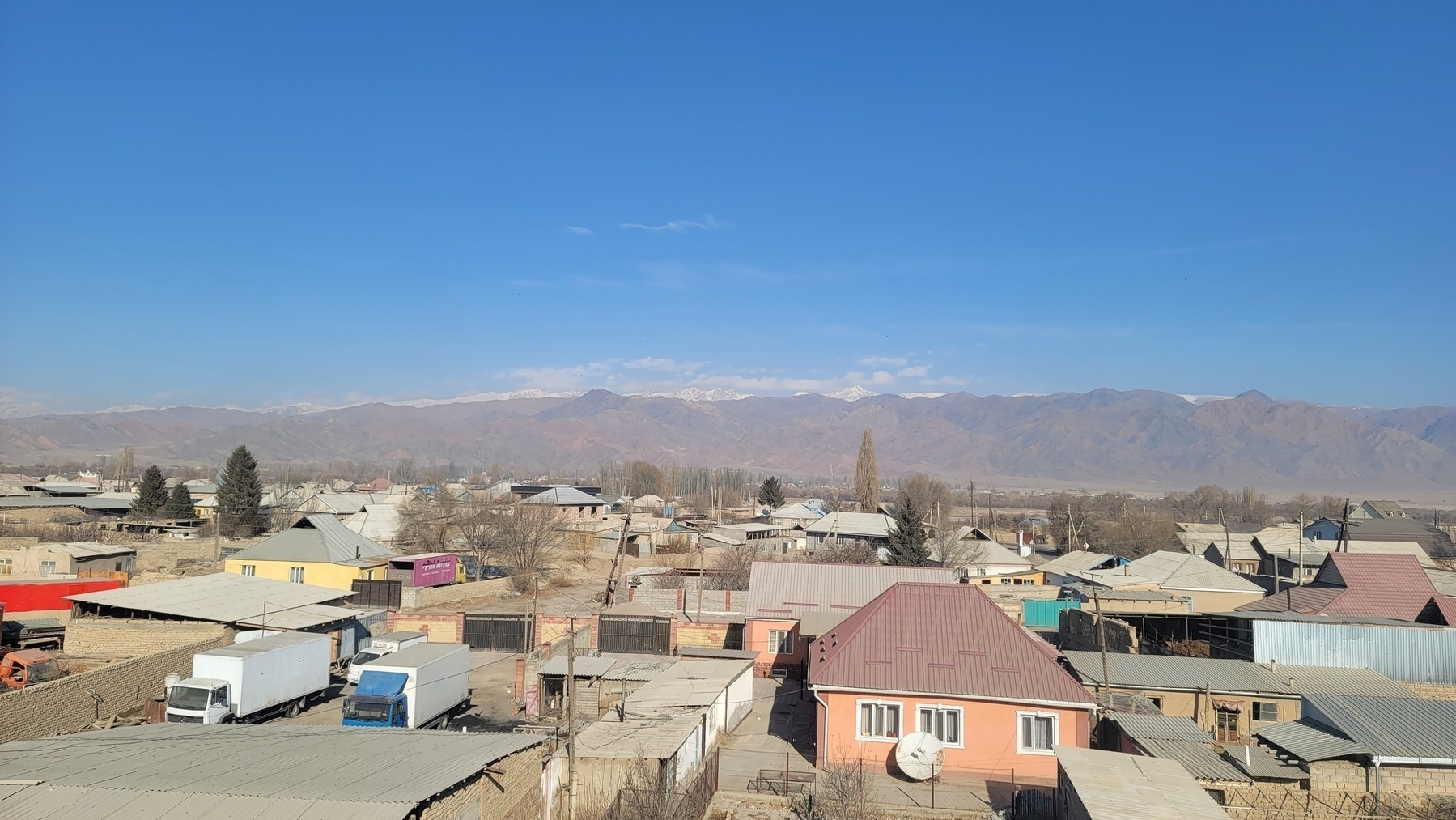 view of houses in a small town, mountains in the background 