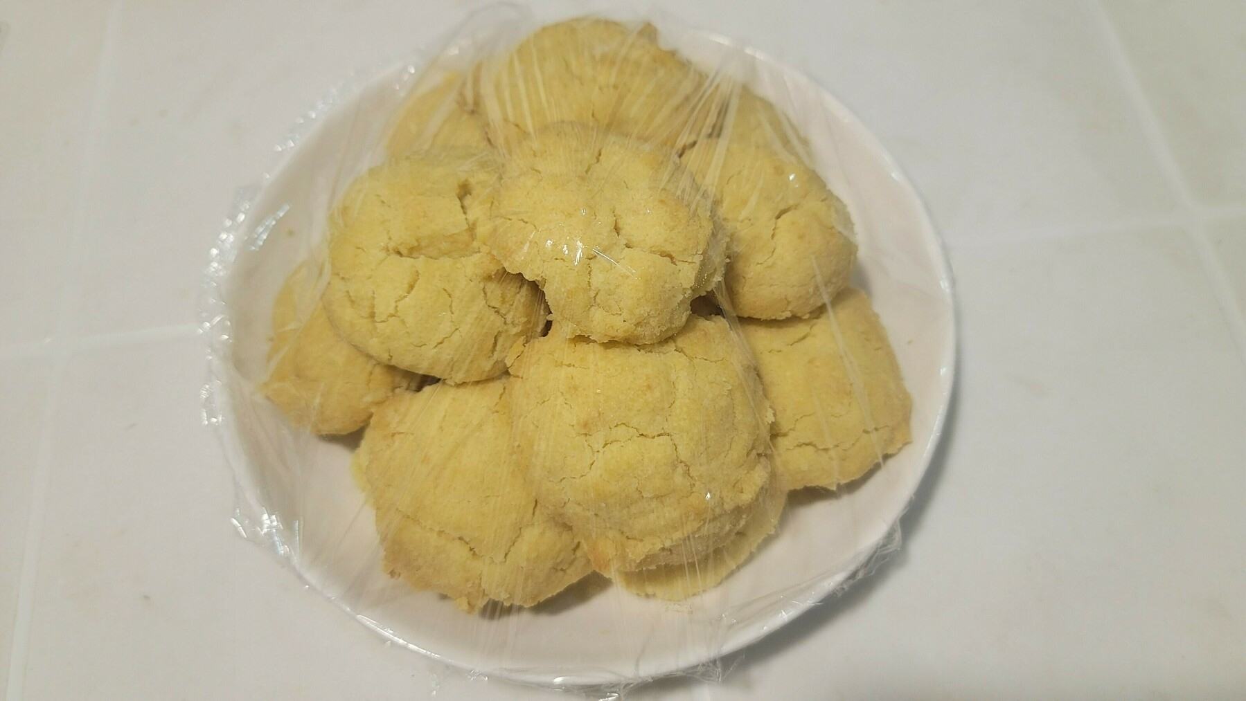 light colored butter cookies on a white plate