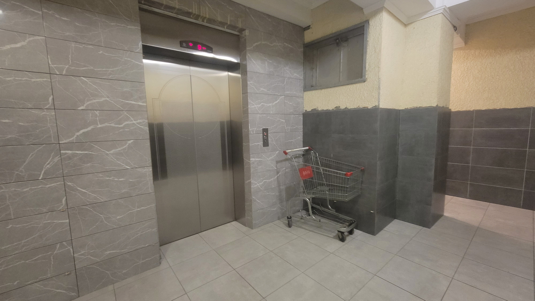 Shopping cart next to an elevator 