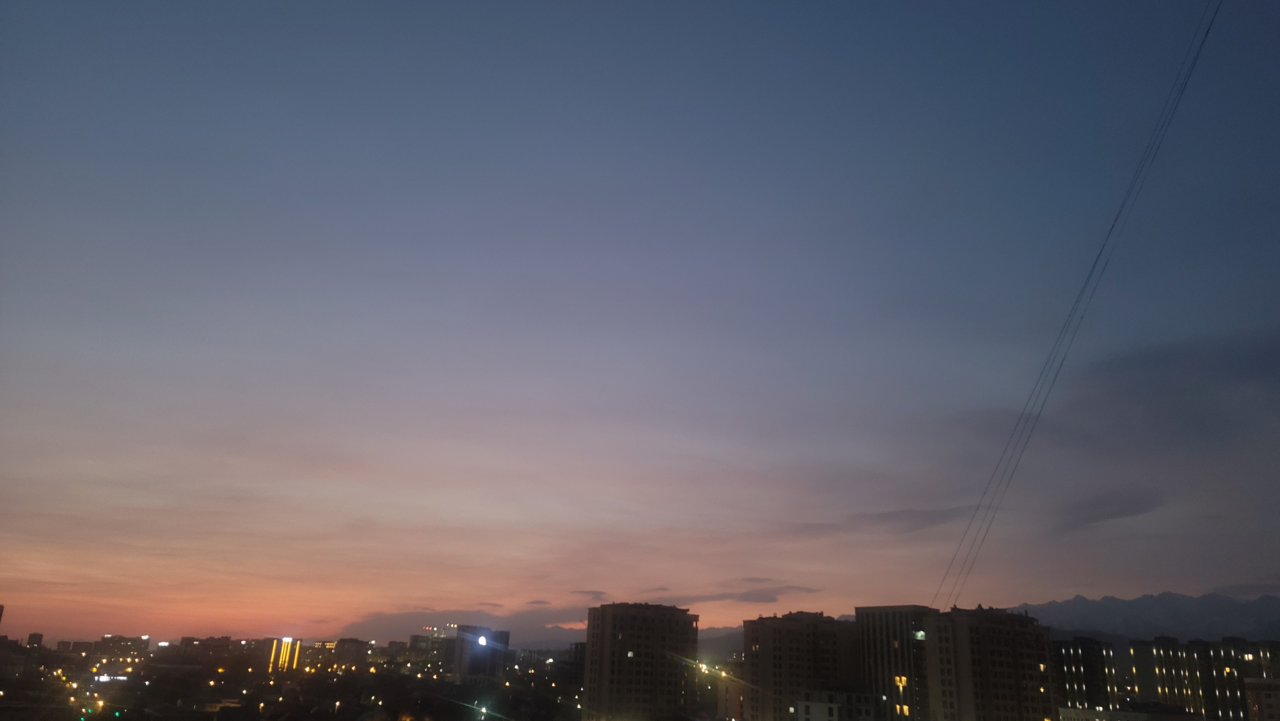 blue and orange sunrise over a city