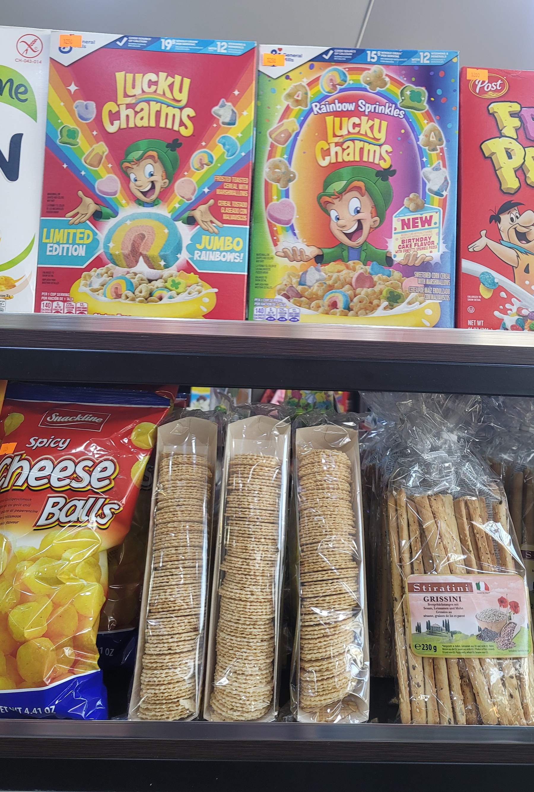 Lucky Charms boxes on a shelf. Fruity Pebbles box partly visible on the right