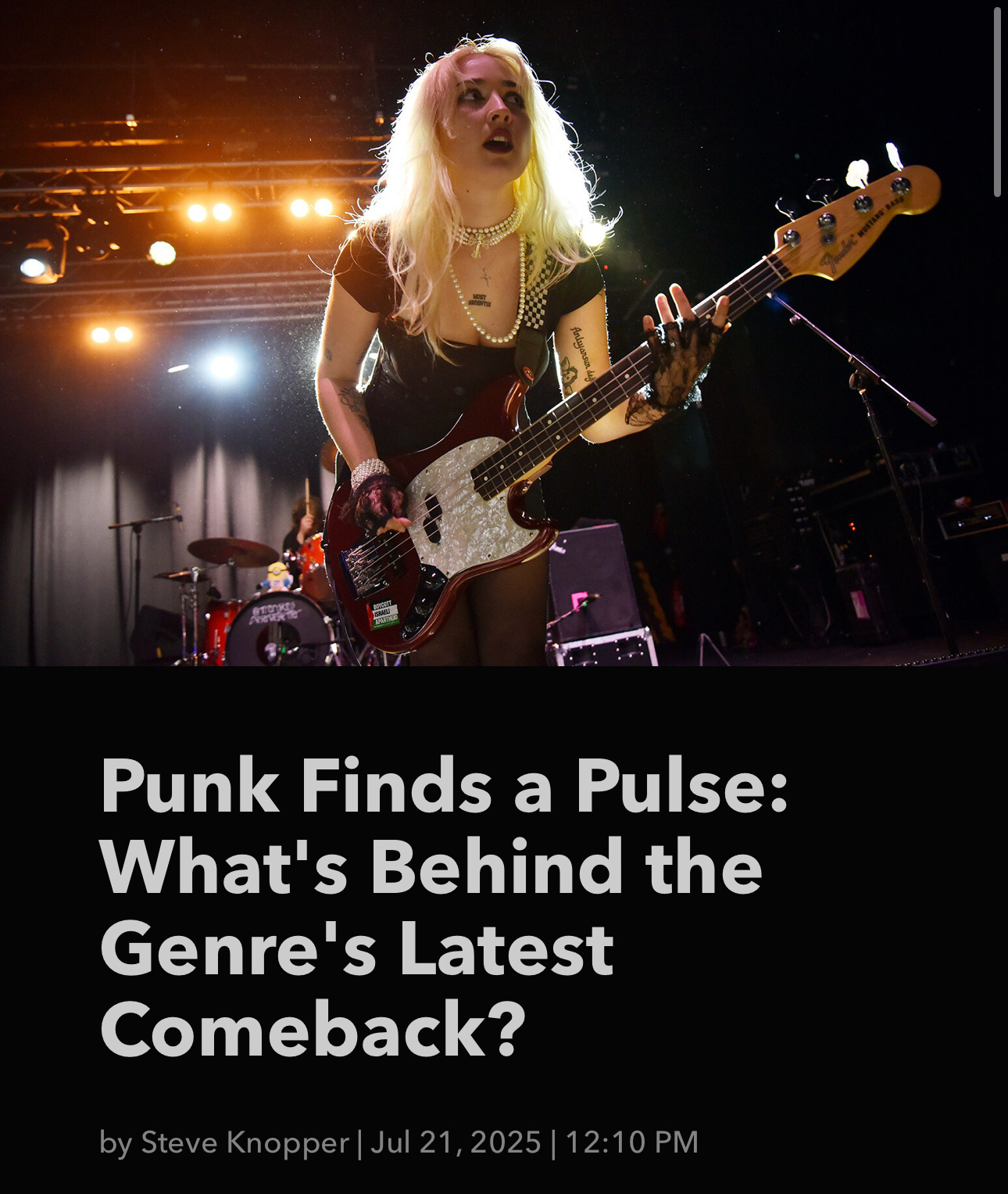 A guitarist with striking blonde hair performs energetically on stage, accompanied by vibrant lighting, alongside a text headline discussing the punk genre's resurgence.