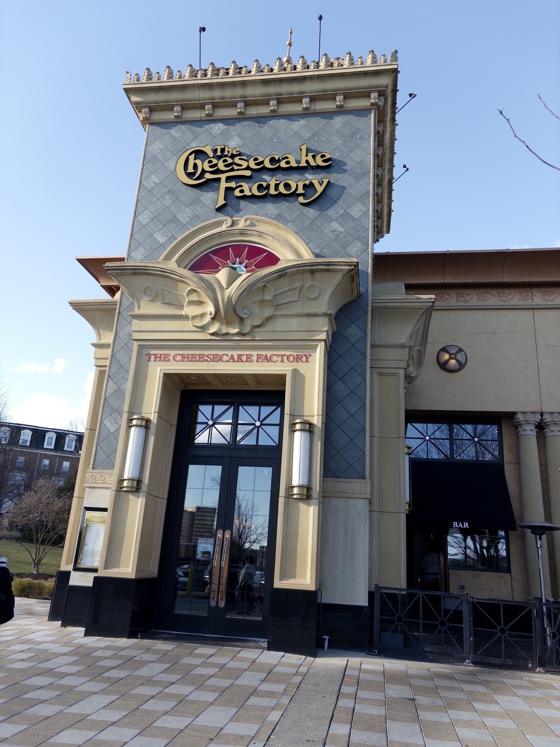 A restaurant entrance featuring the signage for The Cheesecake Factory.