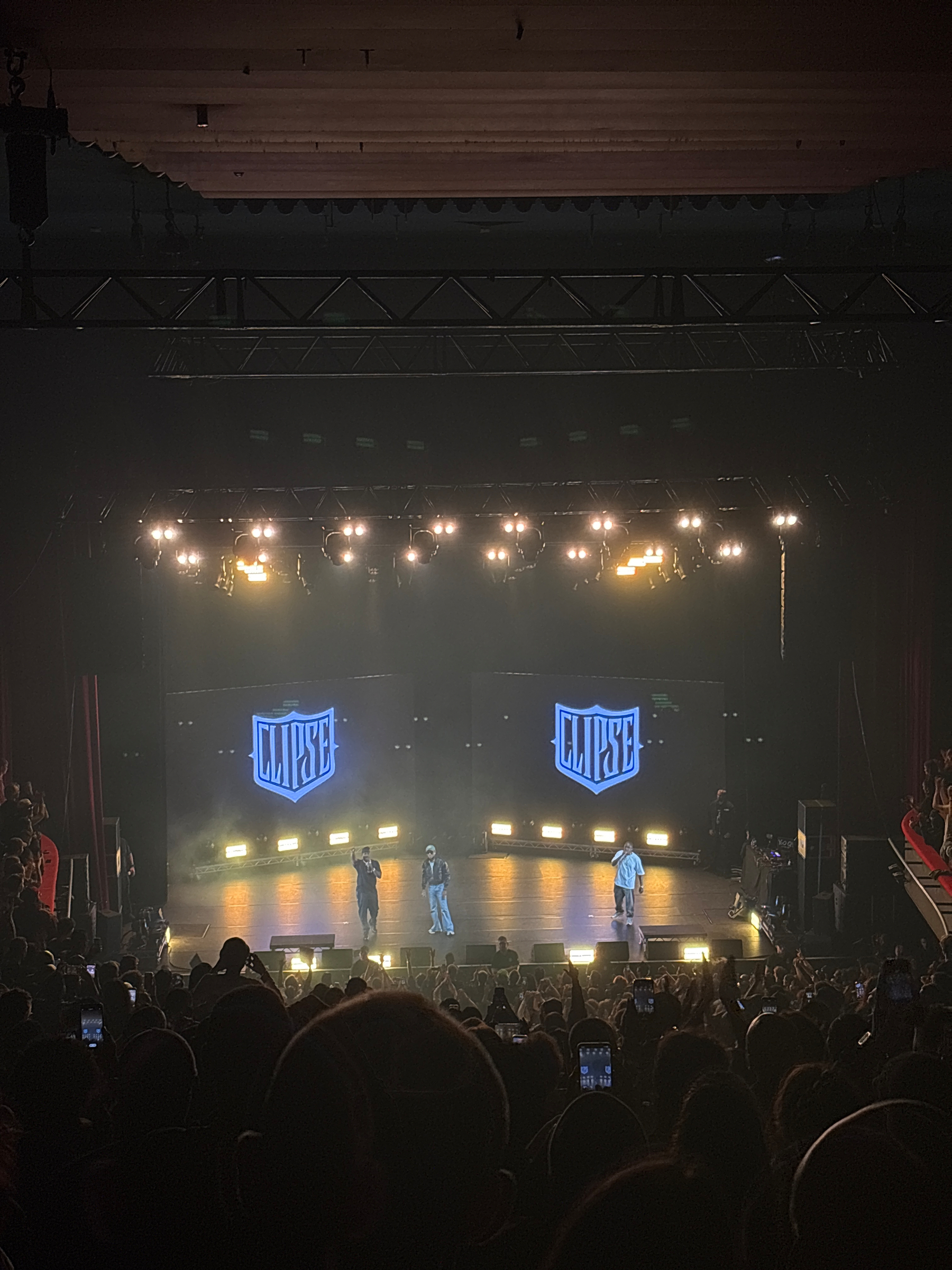 Text in a blue speech bubble reads, Just waiting for the show and Pharrell just showed up, as expected haha.