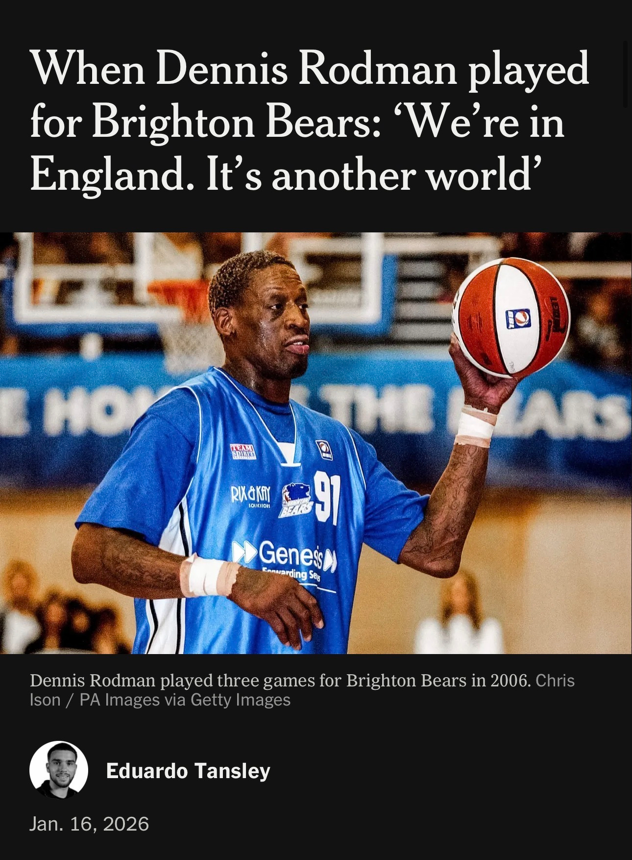 A basketball player in a blue jersey is spinning a basketball on his finger while standing on a court.