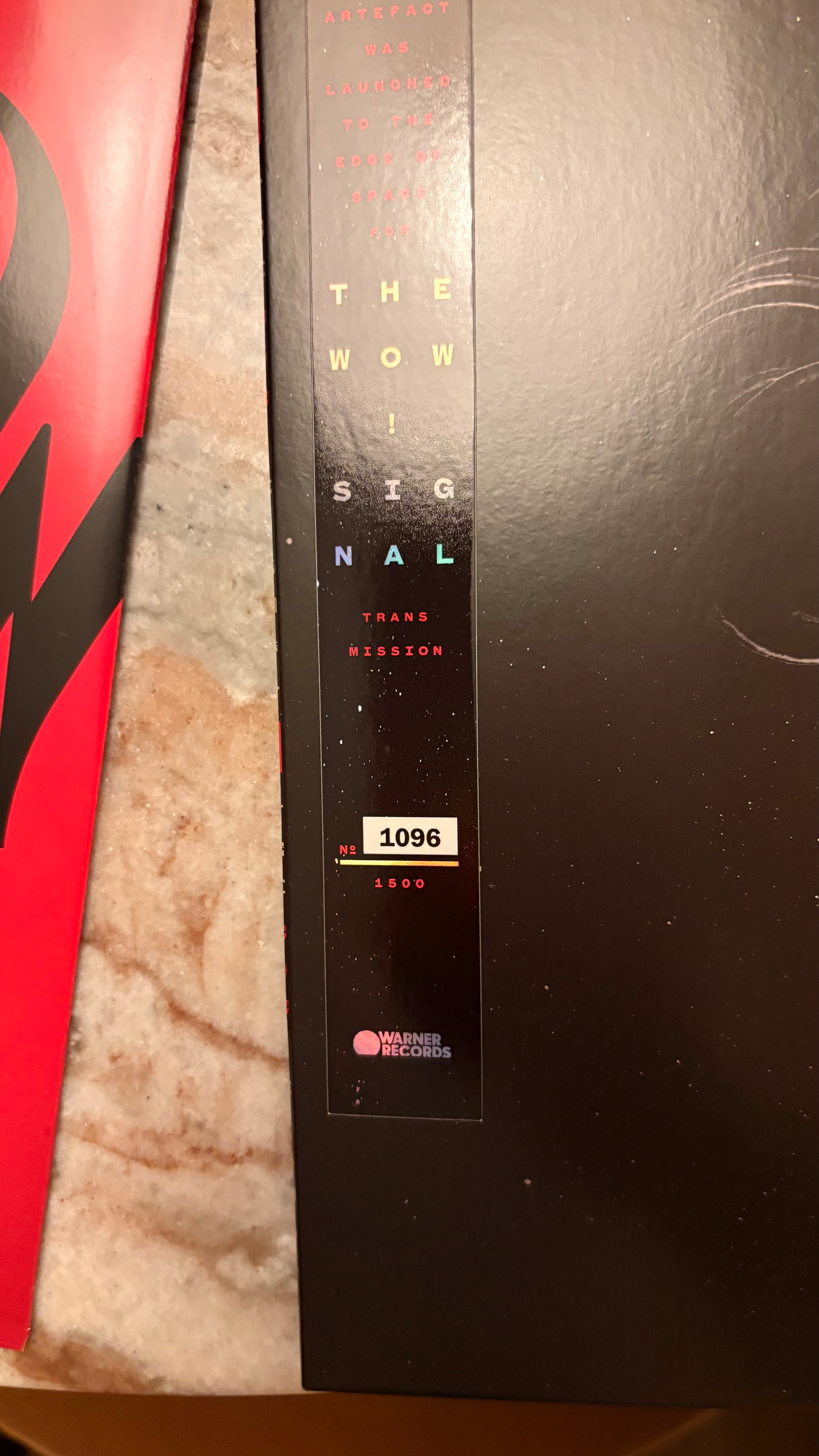 A close-up of a limited edition Warner Records release titled The Wow! Signal Transmission, numbered 1096 out of 1500.