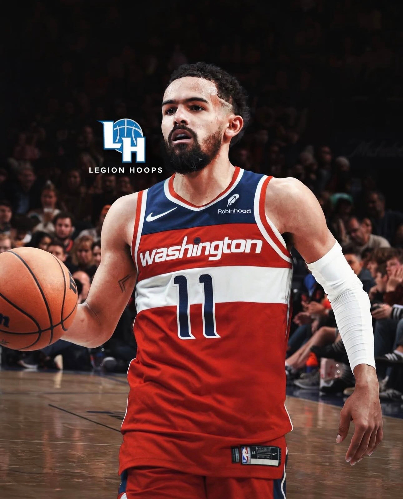 A basketball player wearing a red Washington jersey with the number 11 is dribbling a basketball on the court.