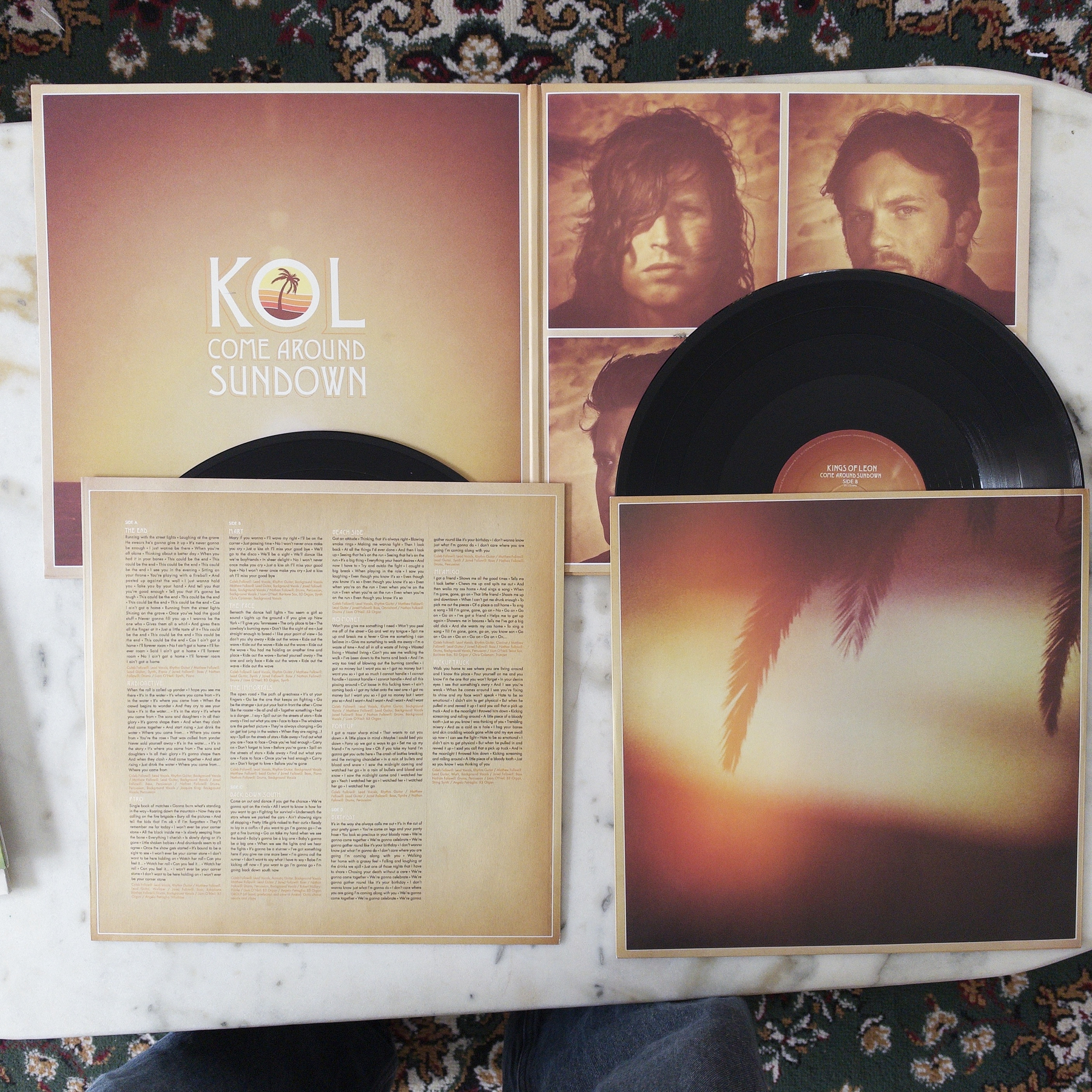 The album Come Around Sundown by Kings of Leon is displayed with its vinyl records, cover art, band member photos, and lyric sheet.