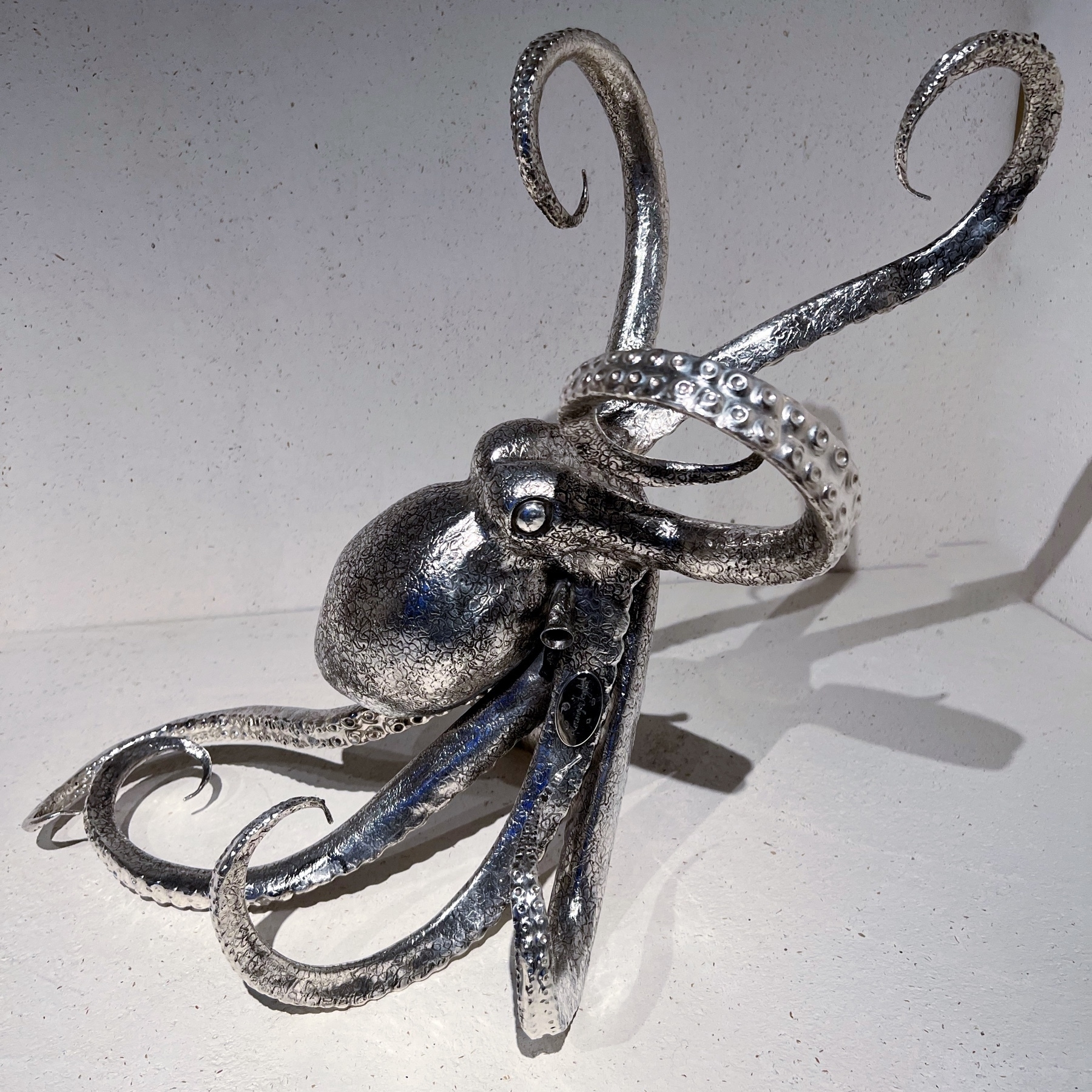 a silver sculpture of an octopus