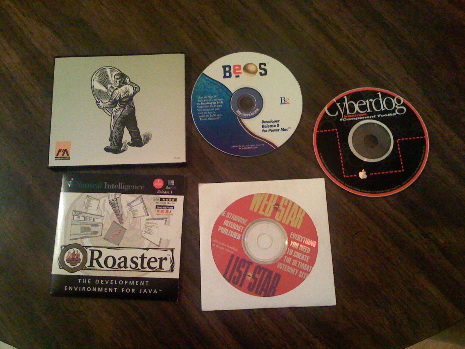 Compact discs and DVDs on a table: CodeWarrior, BeOS, Cyberdog, Roaster, and WebSTAR and ListSTAR.