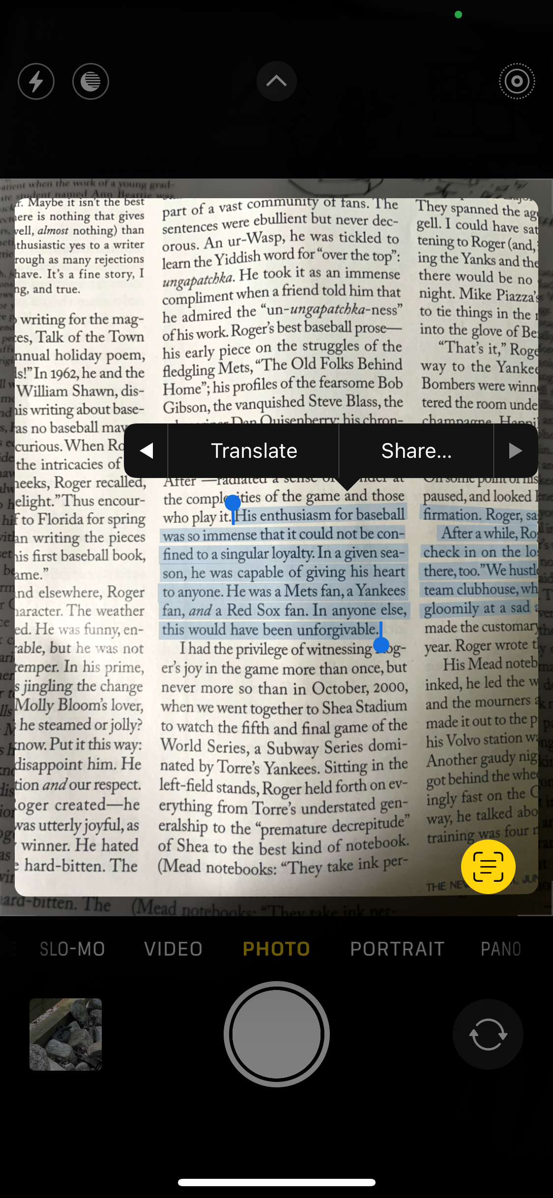 An iPhone screenshot showing text highlighted in the photo being taken using the phone camera's 'LiveText' feature.