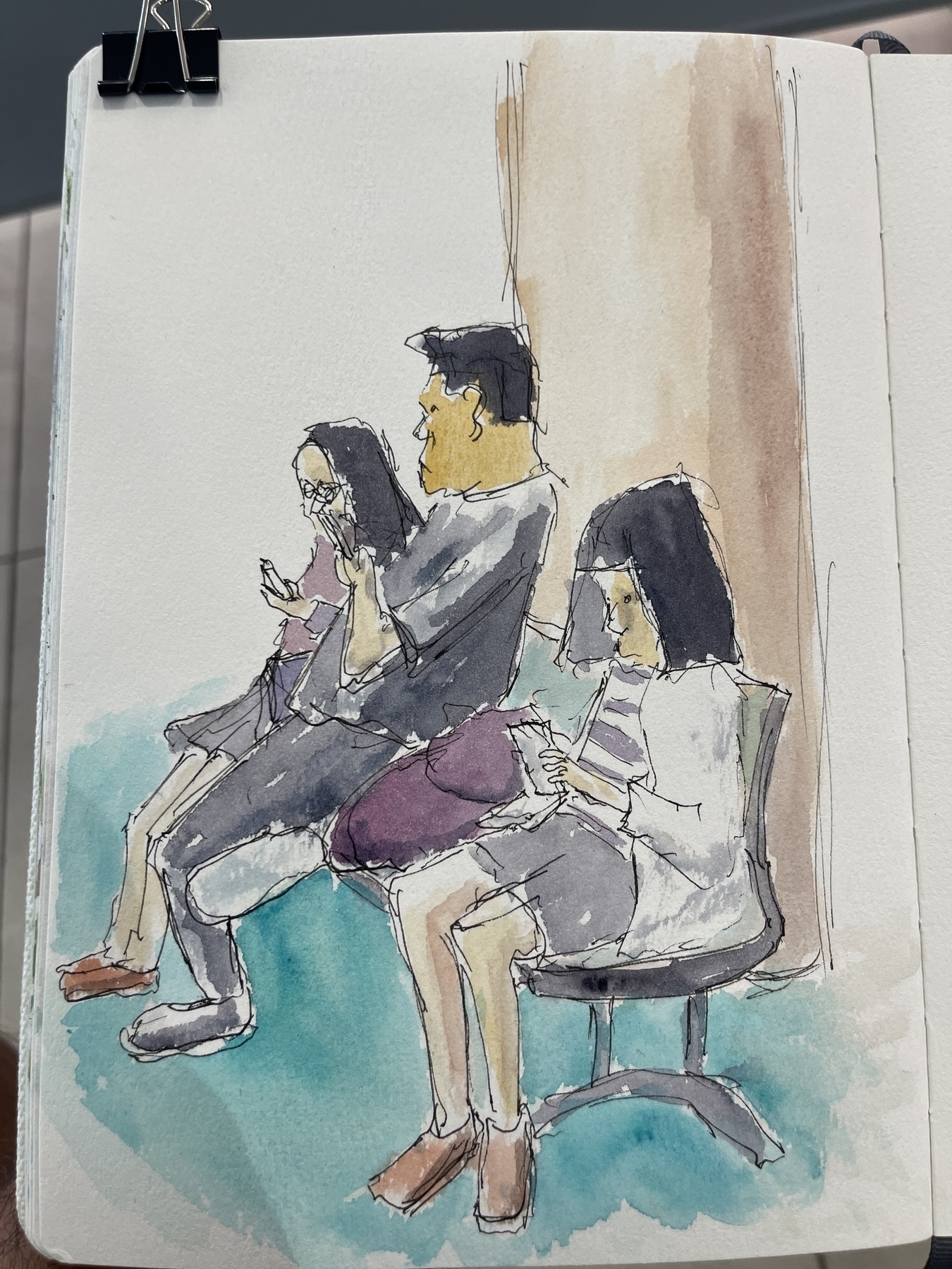 Quick watercolour scribble of a family waiting in the airport