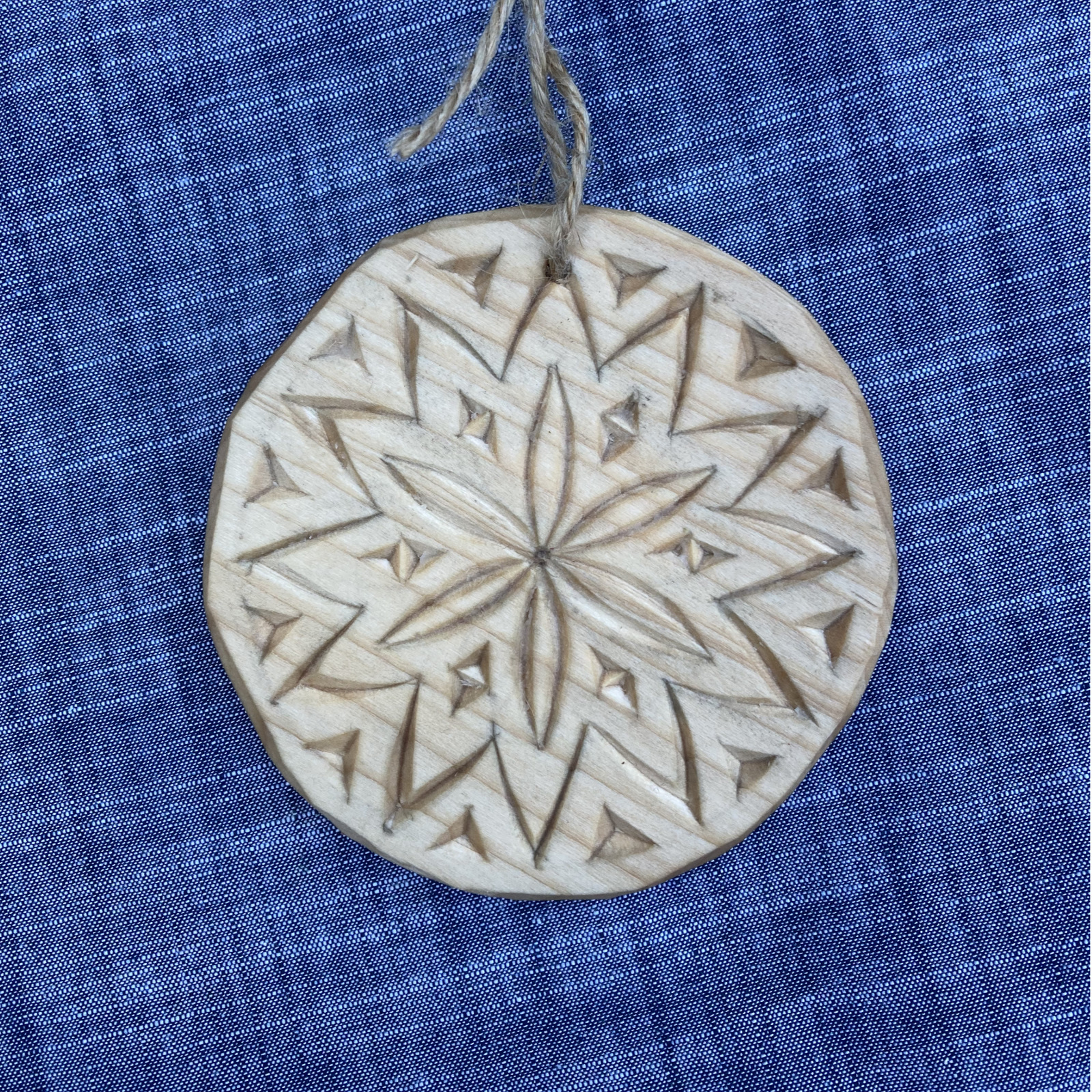 Chip-carved wooden tree ornament with six-point rosette pattern