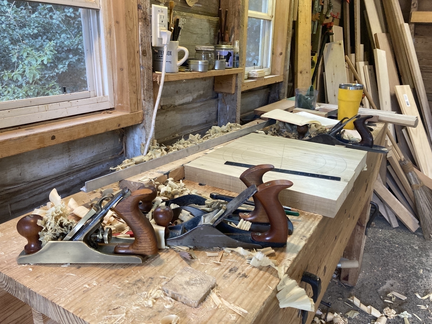one heck of a mess on my workbench. hand planes, wood, shavings