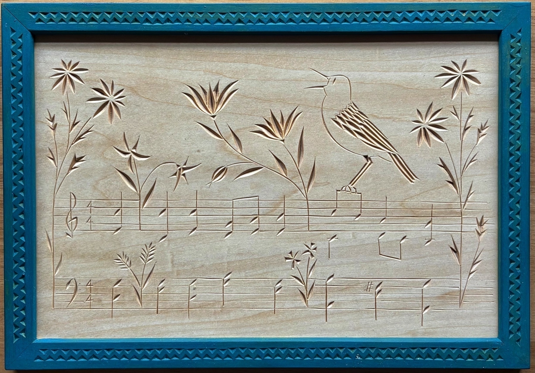 chip carving of bird singing perched on music staves illuminated with flowers