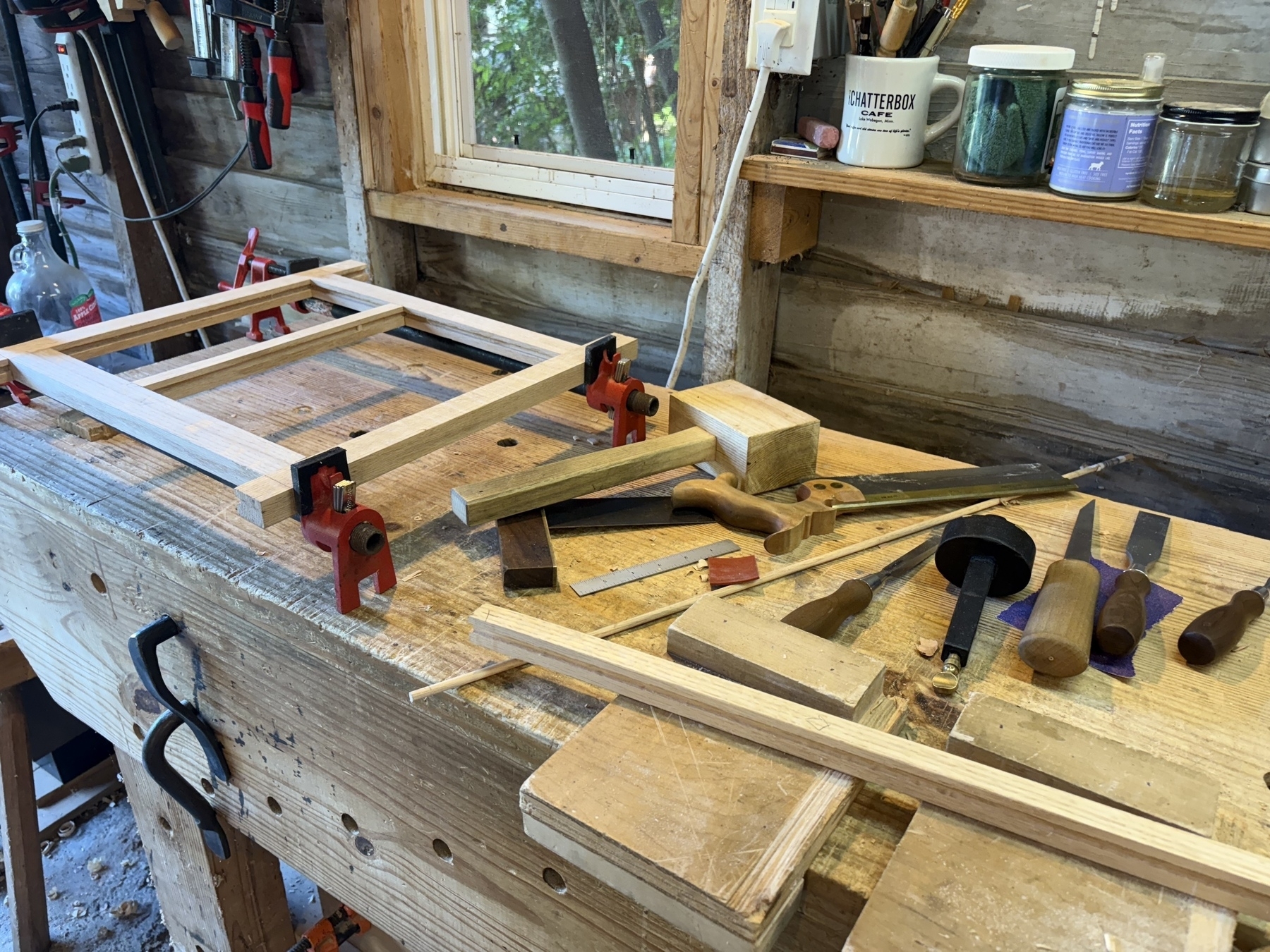 Partially assembled frame and tools on workbench