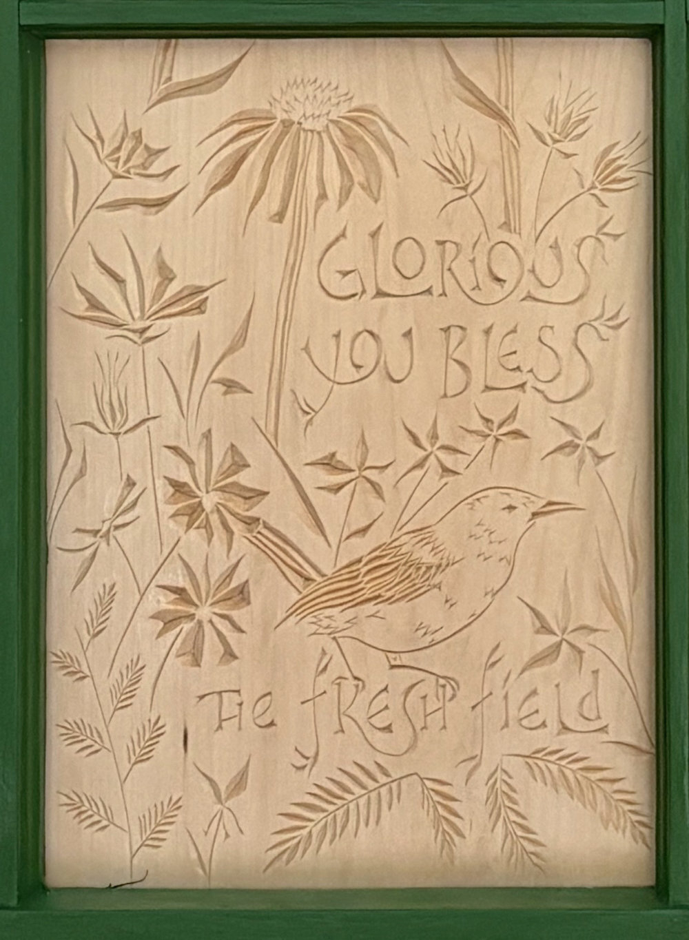 third panel of carving. Text reads "Glorious you bless the fresh fields," wren with various flowers and greenery