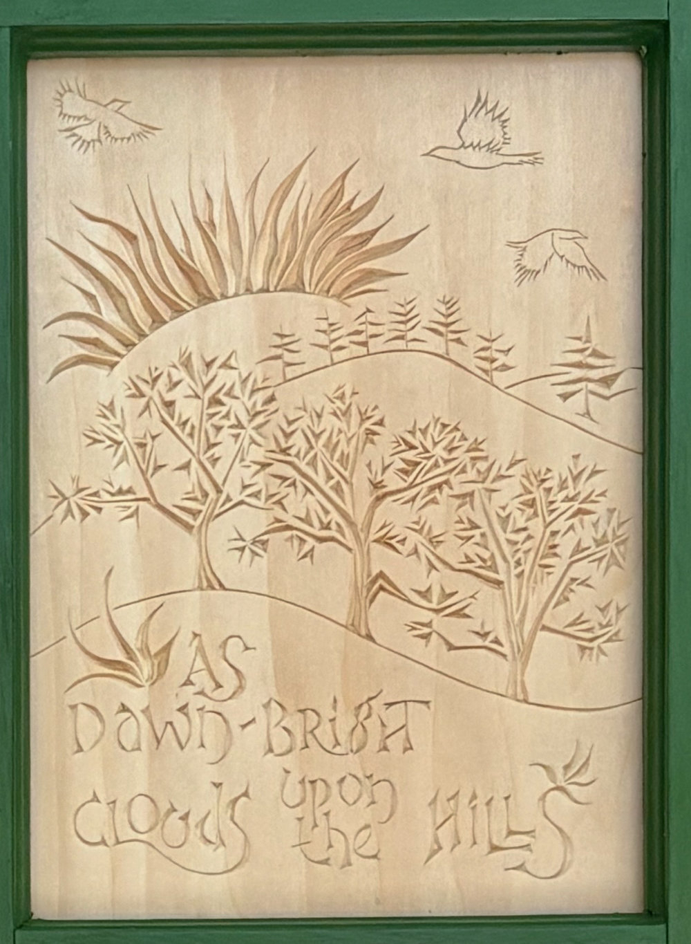 second panel of carving. Text reads "As dawn-bright clouds upon the hills." Trees in middle distance and far distance, sun rising overhead, birds flying at top