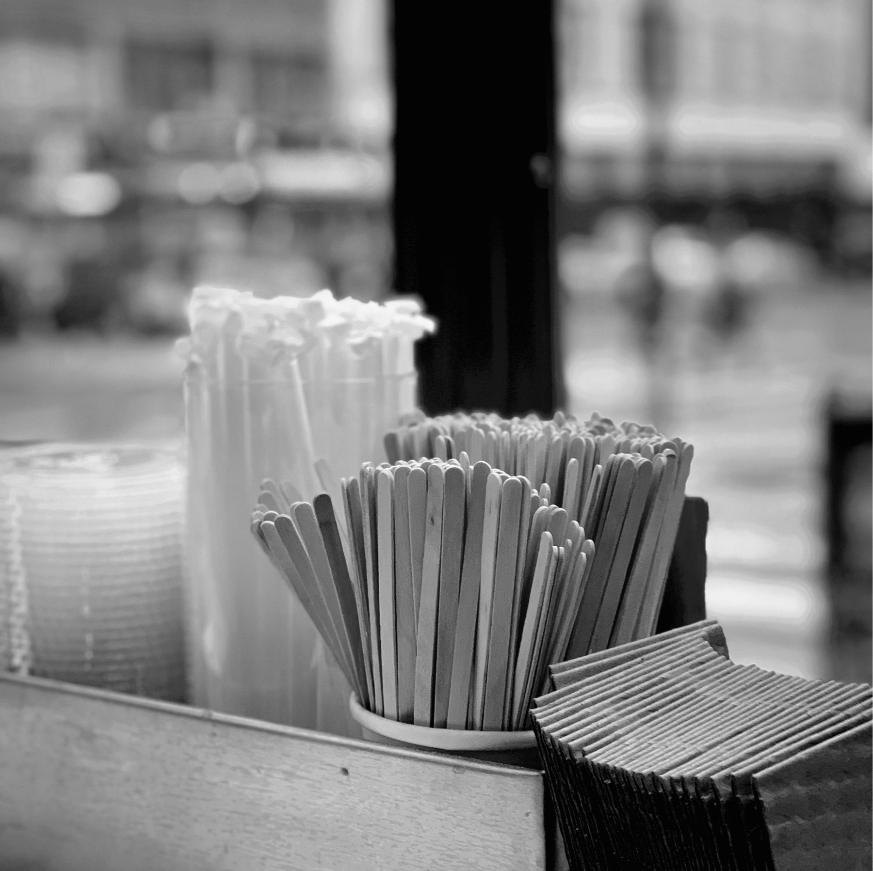 Straws and stirrers in a cafe window.