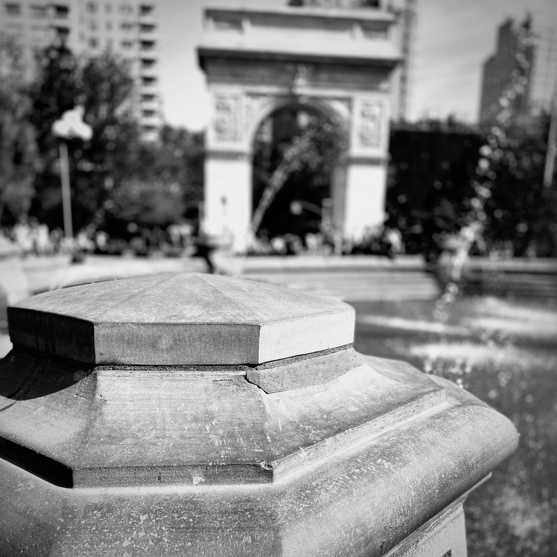 Post from the fountain at Washington Square Park, with arch blurred in background. 