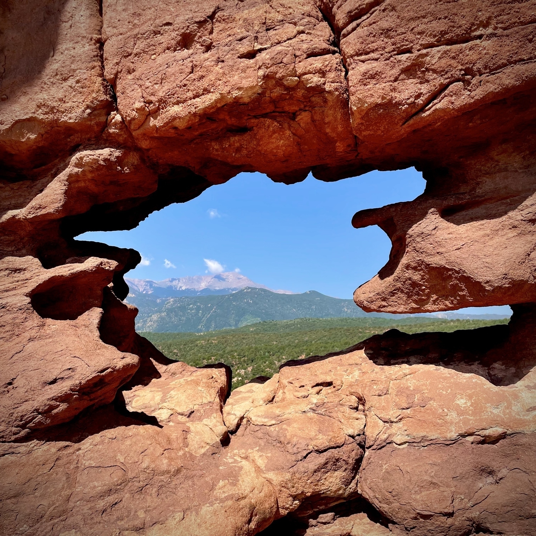 View through the Siamese Twins Rock formation in Garden of the Gods, to Pike's Peak in the distance.