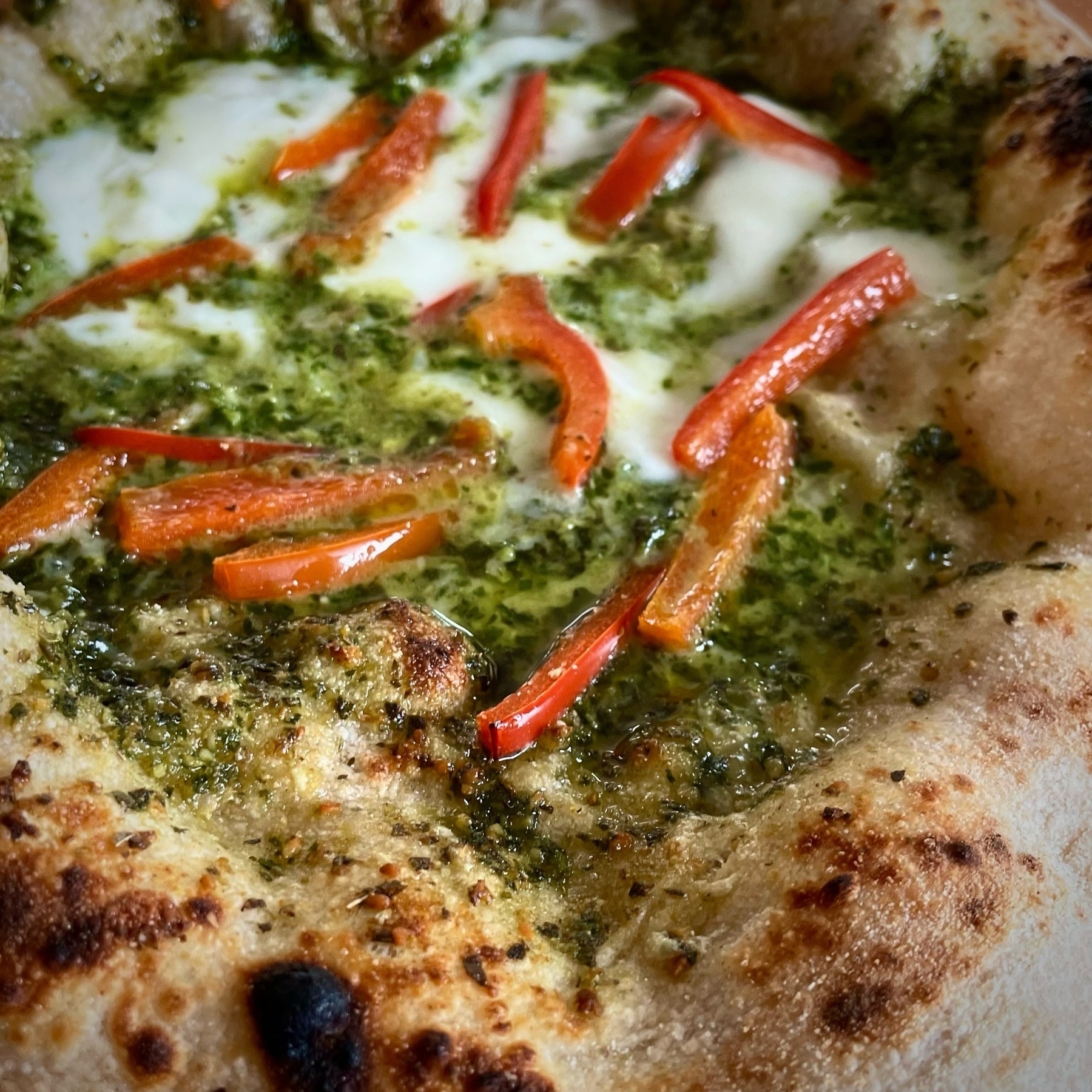 Pizza with pesto, bell peppers. 