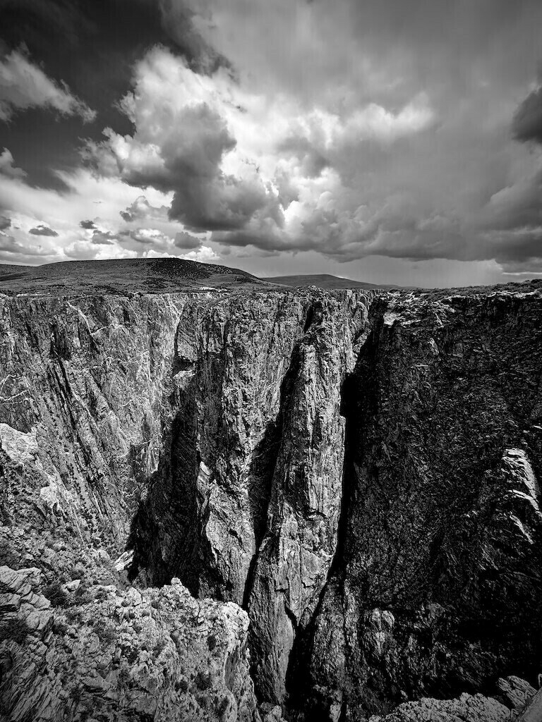 Deep canyon with clouded sky in black and white