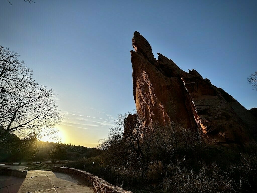 Rock face with blue sky and rising sun