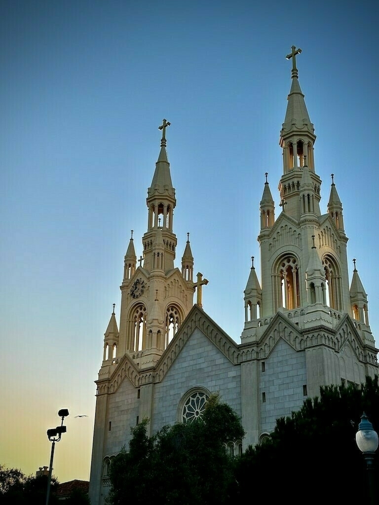 Twin spires of a church at sunset, clear sky. 