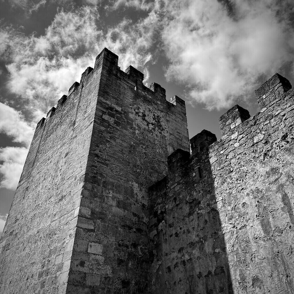 Castle walls. Light clouds. Black and white. 