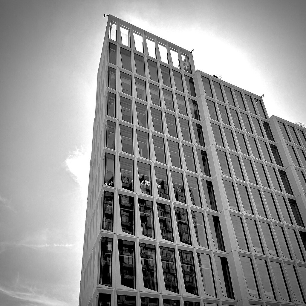 White business building against a clear sky, black and white