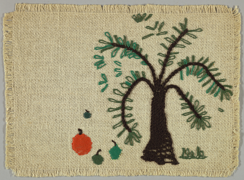 A handmade place mat made out of fibers, showing a tree and some apples on the ground below.